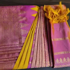 This vibrant pink and yellow silk saree is perfectly box-folded, showcasing how the pallu and pleats are neatly tucked in. It's ready for any client's wardrobe or suitcase.