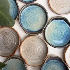 Our spoon rests are always in high demand. This overhead shot shows the beautiful variety of our studio-mixed glazes, including the drippy rutile and earthy shino finishes. Each one is a small piece of functional art for your kitchen.