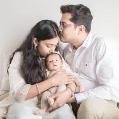 Welcoming a new baby is a milestone for the entire family. I make sure to capture this precious time with portraits that include both parents, creating a timeless image of your new family unit. This is the beginning of your story together, preserved forever.