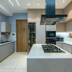 I believe a kitchen should be the functional heart of the home. This design features a clean, open layout with a central island, perfect for cooking and conversation. The soft blue-gray cabinets and handleless design create a tranquil, minimalist look that is both timeless and easy to maintain.