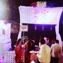 Our dedicated Italian counter is always a popular choice. Here, guests gather to enjoy freshly prepared pasta and other continental delights at an outdoor wedding reception.