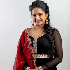 Actress Duniya Rashmi at the Chittara Star Awards. This portrait highlights her beautiful black and red outfit and her warm, engaging smile.