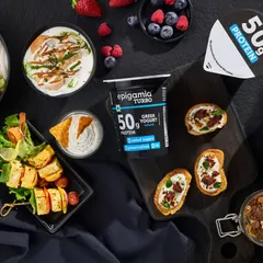 This image shows the versatility of Epigamia's high-protein Greek yogurt. I created a flat lay composition featuring various dishes like a salad bowl, paneer skewers, and dips to illustrate how the yogurt can be used in many healthy recipes.