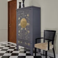 In this Worli residence, I used my favorite black and white checkered flooring to create a classic foyer. Instead of a typical console, I sourced a stunning grey oriental wedding cabinet that cleverly houses a coffee and snack station for the family.