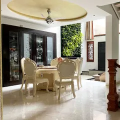 We brought the outdoors in by incorporating a lush vertical garden next to the dining area in this Bengaluru residence. This biophilic design element provides a refreshing natural view, perfectly complementing the elegant, classic furniture and polished marble floors.