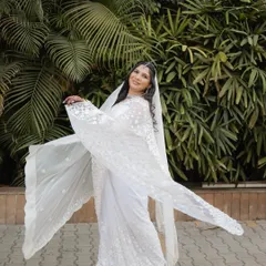 A joyful shot of our Buddhist bride in a stunning white saree. Her makeup is subtle and natural, allowing her radiant smile to be the centerpiece.