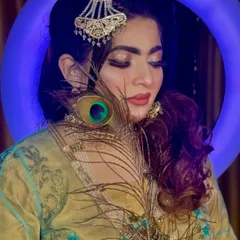 The glittery eye makeup in this shot is absolutely mesmerizing. The peacock feather adds a touch of mystique and artistry to the portrait.