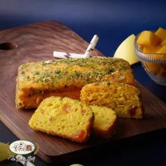The Mango Bar Cake is a moist and flavorful tea cake infused with mango puree and chunks of real mango, perfect for an afternoon snack.