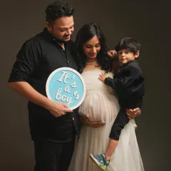It's a boy! This family shares their happy news during their maternity session, with their son looking on. It's a wonderful way to include the whole family in the excitement and anticipation.