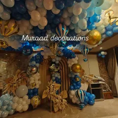 A full view of the hot air balloon-themed room decoration. This image captures the balloon-covered ceiling, the grand entrance arch, and other themed elements that completely transform the space.
