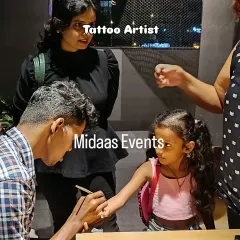 A tattoo artist carefully paints a design for a young guest. This activity provides a great photo opportunity and gives the kids a fun, temporary souvenir to remember the party by.