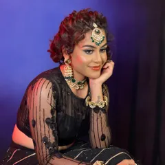 An Indo-Western look created for a professional makeup course. This style features dramatic, colorful eye makeup and a curly updo, paired with modern jewelry.