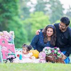 This family portrait was part of a first birthday celebration. I use props like flowers and signs to add a personal touch to milestone photoshoots, while keeping the focus on the family's connection.