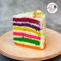 A slice of our vibrant Rainbow Pastry. With its colorful layers and light, creamy frosting, it's a feast for the eyes and the palate, perfect for brightening up your day.