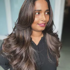 Another look at the Butterfly Haircut, showing how the layers fall beautifully whether the hair is styled straight or with waves. It's a versatile cut that adds glamour and texture.