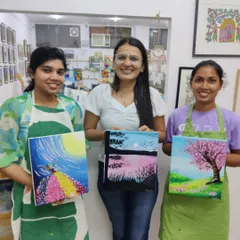 A group of friends after a successful canvas painting workshop for adults. It's a perfect way to socialize, relax, and leave with a piece of art you created yourself.
