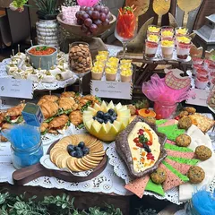 A "He or She" themed baby shower grazing table with pink and blue accents. We included a variety of treats like croissants, fruit tarts, and cheese platters to delight guests celebrating the new arrival.
