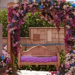 We love creating whimsical corners that become the heart of the celebration. This traditional swing, completely enveloped in a lush arch of pastel florals, became a dreamy photo spot for the couple and their guests at this Mehendi.