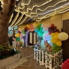 The entrance to this jungle party was a magical path under a tree, decorated with a rainbow balloon arch and friendly animal cutouts.