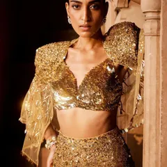 Embrace your inner radiance with this all-sequin ensemble. The dramatic puffed sleeves and dazzling gold texture are crafted for moments when you want to be the center of attention.