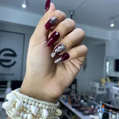 A bold and glamorous bridal look featuring coffin-shaped extensions. The design combines a rich maroon gel polish with full-coverage silver crystal accent nails for maximum sparkle.