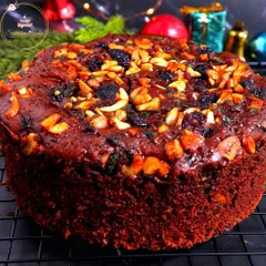 A close-up view of my handcrafted Christmas plum cake, cooling on a wire rack. You can see the rich texture and the abundance of premium nuts and fruits that I bake into every single cake.