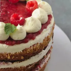 A close-up of the layers in my Fresh Raspberry Tiramisu cake, showing the fresh fruit compote and creamy, egg-free tiramisu filling.