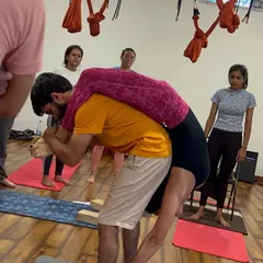 Partner adjustments are a key part of our YTTC. Students learn how to safely assist each other in deep stretches and poses.