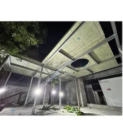 A night shot of the Business Hub under construction. The image shows the ceiling structure being installed, with openings for skylights and services integrated directly into the sustainable panel system.
