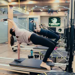 This beautiful side-bending "Mermaid" stretch on the Reformer opens up the entire side of the body. It's a perfect example of how Pilates lengthens and tones simultaneously.