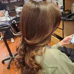 The back view of the layered cut and blowout. You can see the distinct layers that create shape and reduce weight, allowing for maximum volume.