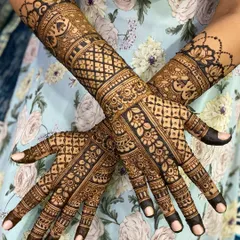 A full-coverage traditional mehandi design, showcasing intricate jaal (net) patterns, delicate floral work, and bold, clean lines. This style is perfect for anyone who loves a rich, detailed henna look.