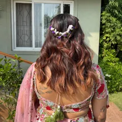 A closer look at the floral hair accessory. Using fresh flowers in the hair is a wonderful way to elevate any traditional or bohemian look.