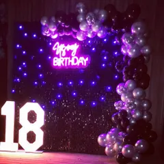 Turning 18 is a huge moment, and we marked the occasion with this chic setup. The black sequin wall with purple LED lights, a custom neon sign, and a black and silver balloon arch made for a stylish and modern party atmosphere.