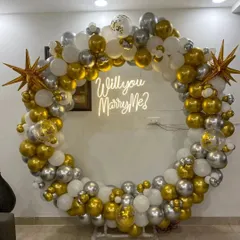 For that unforgettable moment, I design stunning proposal backdrops. This setup features a large ring decorated with gold, silver, and white balloons, with a "Will you Marry Me?" neon sign to make the question pop.