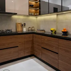 This kitchen combines the warmth of wood with a clean, modern aesthetic. The lower cabinets are finished in a rich wood grain, while the upper cabinets are a mix of glossy white and glass. Under-cabinet lighting provides excellent task lighting and highlights the stone backsplash.