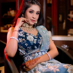 The client is getting her final touches done in the studio, wearing the beautiful teal lehenga. This shows how I help you get ready from head to toe.