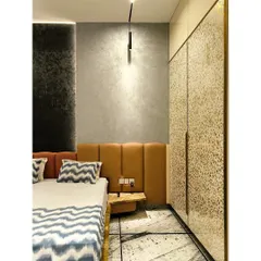 A detail shot highlighting the textures of the wall, headboard, and wardrobe, showcasing a masterful blend of materials.