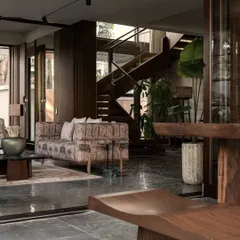 This shot captures the flow from the patio back into the living space, highlighting the wooden staircase. The use of walnut wood throughout the home brings warmth and a cohesive feel to the different zones.