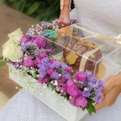 A side view of the Starlet Hamper, highlighting the fresh purple and white flowers that we nestle alongside the bento cake, wine, and other selected treats.