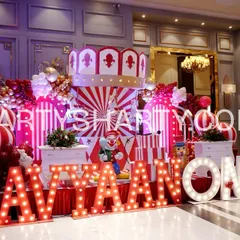 We bring the fun of the fair to you with our spectacular Carnival themes. This setup includes a custom carousel-style backdrop, classic red and white stripes, and personalized marquee letters that create an atmosphere of excitement and wonder.