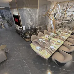 An overhead perspective of an open-plan living and dining area. We designed the layout to facilitate social flow, with a custom ten-seater marble dining table under a sculptural chandelier, adjacent to a comfortable lounge space for seamless entertaining.