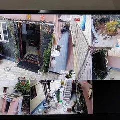 This monitor shows a live feed from a 2MP Hikvision IP camera system with audio. It covers multiple outdoor and indoor areas of a residence clearly.