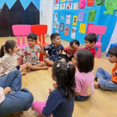 A typical day in our class involves group discussions and storytelling circles, where children learn to listen, take turns, and share their ideas.