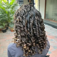 Varshini's curls were treated with Manetain’s new Bond Repair Therapy after her color service to maintain the health and integrity of her beautiful curl pattern.