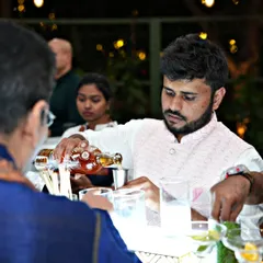A close-up of our bartender carefully measuring and pouring a spirit for a custom cocktail. We pride ourselves on consistency and quality in every glass served at our events.