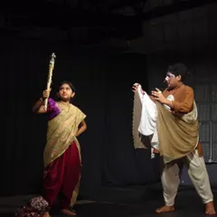 Two young actors completely in character during a scene from their play, showcasing the incredible talent nurtured at our workshops.
