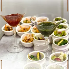 An elegant presentation of assorted single-bite appetizers and colorful dips served in martini glasses. These small wonders are packed with flavor and perfect for mingling.