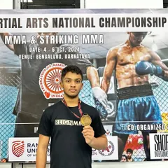 Almeer, one of my dedicated MMA fighters, proudly displaying his gold medal from the Martial Arts National Championship. This was his first fight and first win, the start of a long and successful career.