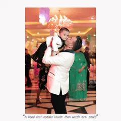 A father's love captured in a single, candid moment. He lifts his son high in the air during the birthday celebration, a memory of pure joy.